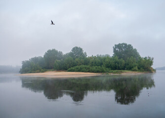 A calm lake with a cloudy sky in the background.