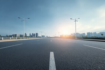 Fototapeta premium Cityscape Highway at Sunset: Modern Urban Road with Skyline, Asphalt Surface, and Bright Sunlight