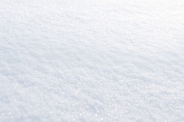 Obraz premium A smooth, sparkling layer of fresh white snow glistens in soft winter sunlight, creating a peaceful and minimal seasonal background for any design.
