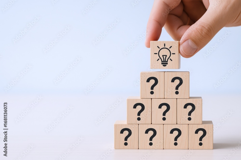 Poster creative problem solving: hand placing idea block atop question blocks pyramid, symbolizing innovati
