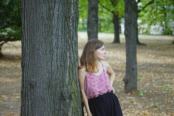 Female model leaning on tree, looking in dreamy way. Concepts for advertising about hope,...