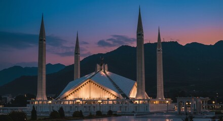 Faisal Mosque Islamabad with dramatic mountain backdrop and evening lights