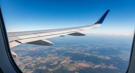 Obraz premium Airplane Wing Over Landscape.