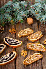 poppy and walnut roll cakes, pine branch, old wood table