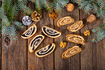 poppy and walnut roll cakes, pine branch, old wood table