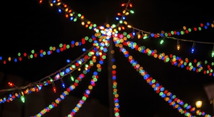 Vibrant Multicolored String Lights with Bokeh Effect Radiating from a Central Point at Night