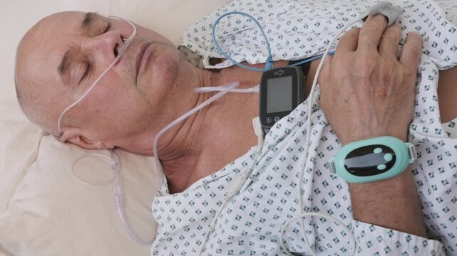 elderly man with sleep apnea monitoring device and fingertip pulse oximeter, senior male patient health tracker, adolescent sleep study equipment, breathing disorder research concept