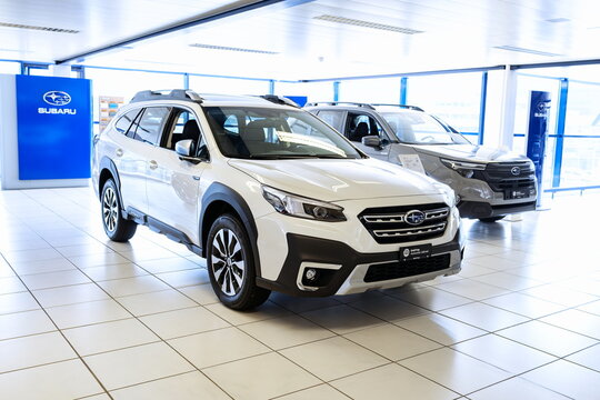 Safenwil, Switzerland, August 16, 2025. New Subaru Outback midsize station wagon exterior view. Emil Frey open days showroom floor, wide angle view, window light