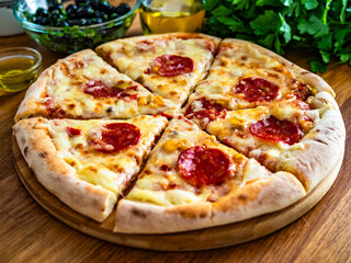 Pizza pepperoni with mozzarella cheese on wooden table	