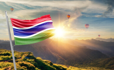 The Gambia flag waving in beautiful scenery. The Gambia national flag for independence day.