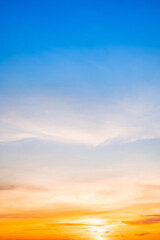 Beautiful , luxury soft gradient orange gold clouds and sunlight on the blue sky perfect for the background, take in evening,Twilight, Large size, high definition landscape photo,Vertical