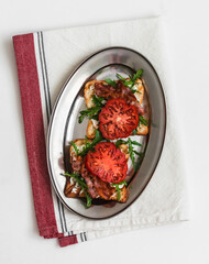 Grilled toasts with cheese, arugula, bacon and tomato - delicious appetizer, tapas, snack,...
