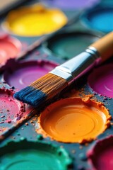 Obraz premium A close-up shot of a paintbrush resting on a vibrant, colorful palette, ready for artistic creation The bristles are slightly splayed, hinting at recent use , visual art, artist