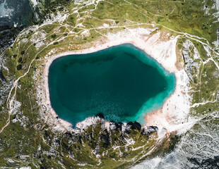 Vertical view of turquoise alpine lake with rocky shore in the Dolomites Italy ideal for nature and...