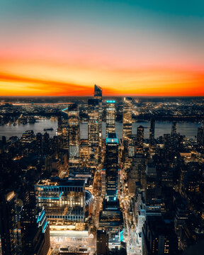 Paris skyline at sunset with warm orange glow and silhouettes of historic rooftops, HDR cityscape