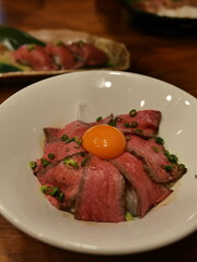 Delicious Japanese Beef Rice Bowl with Egg Yolk and Chives