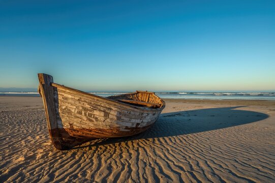 Debris of a broken vessel scattered on sandy shores