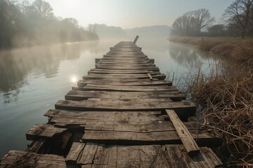 Fototapeta premium Dilapidated wooden bridge spanning the river at dawn