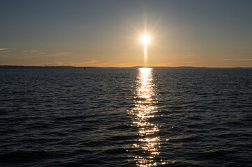 Golden sunset reflection over Lake Bodensee with silhouettes