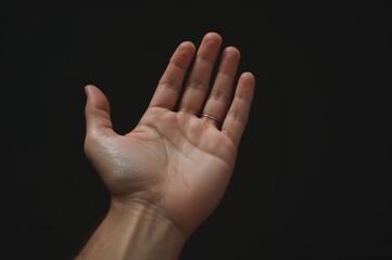 The idea of divine redemption shown by open hands raised in praise