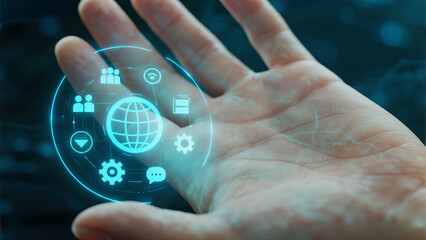 A hand interacts with a holographic UI showing global network and tech icons.