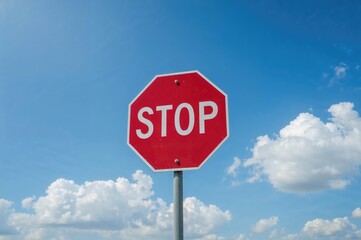 Red Octagonal Stop Sign Against Clear Blue Sky