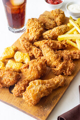 Chicken wings, breasts, legs, nuggets fries and French fries. Fast food. American cuisine.