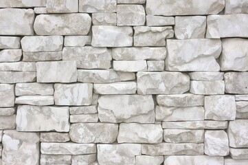 Fototapeta premium Surface of a stone wall featuring shades of white and gray