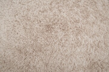 Top view of a chic light beige rug on a white background