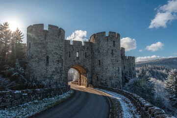 Ancient fortress gateway framed by icy dawn light