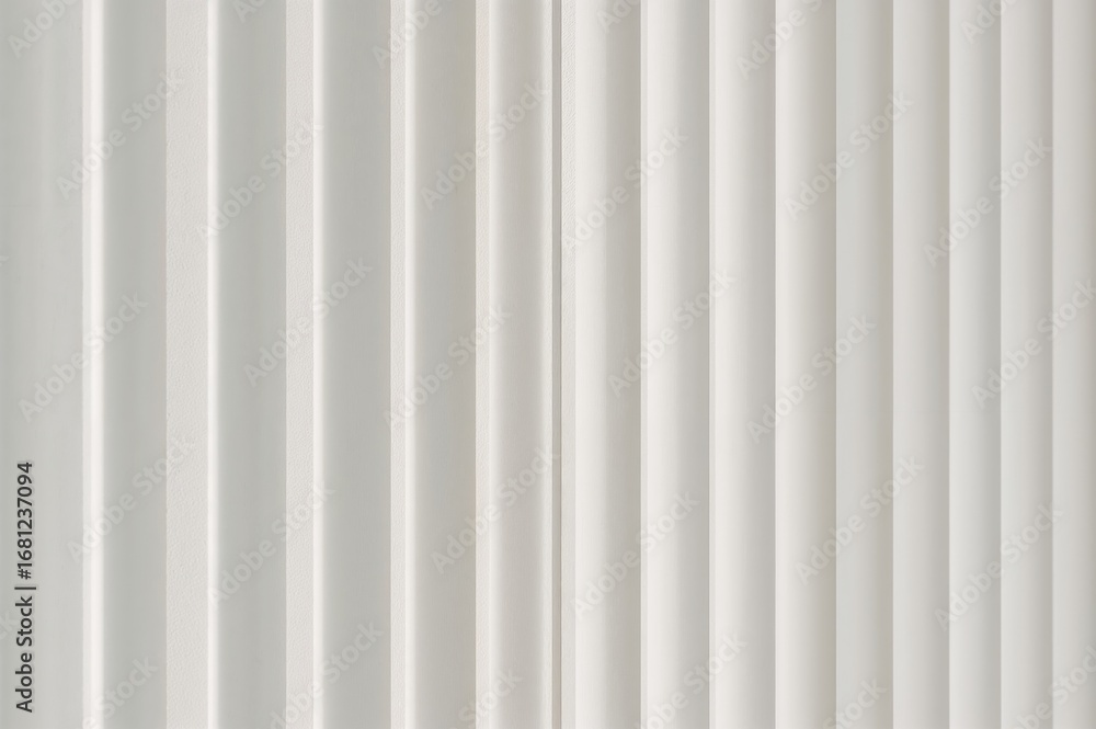 Poster close-up abstract background of vertical white blinds casting shadow patterns on a wall