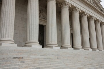 Close-up of stone columns and stairway elements on a building exterior