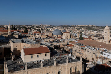 View looking east over the Old City of Jerusalem with notable landmarks: Lutheran Church of the Redeemer, Holy Sepulchre Church with its grey cupola and Mt. Scopus in the distance.