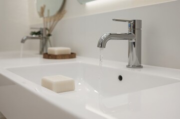 Bathroom sink with soap bar and tap