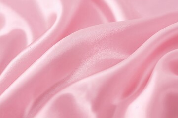 Soft and luxurious texture of pink fabric with subtle waves and folds, featuring a shiny satin surface perfect for design backgrounds.
