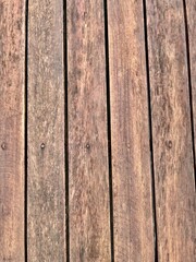 Close-up view of weathered wooden planks forming a deck or patio surface.