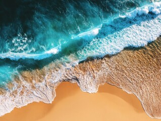 Fototapeta premium Aerial view of ocean waves crashing on sandy beach; turquoise water meets golden sand; tropical paradise from above