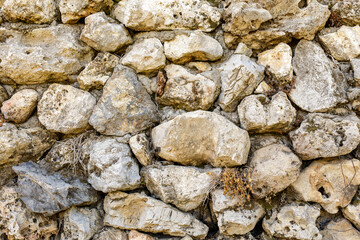 High-resolution image of a rustic stone wall, perfect for backgrounds and textures.  Ideal for design projects.