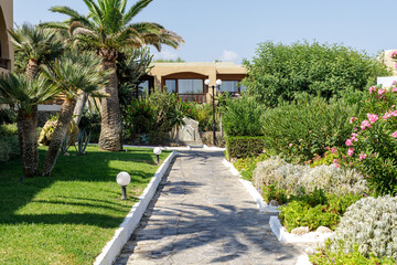 Picturesque pathway through a lush Mediterranean garden. Perfect for travel, hospitality, and...