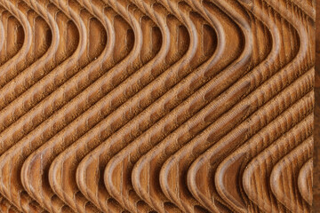 High-resolution image of a brown wood texture with a repeating wave pattern. Ideal for backgrounds, design, and textures.