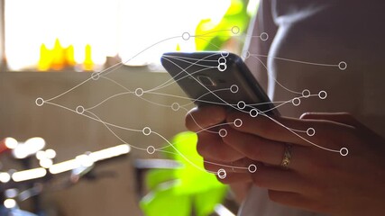Animation of network of connections over mid section of woman using smartphone at home - Powered by Adobe