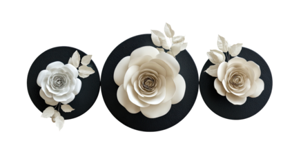 Three cream-colored paper roses, with leaves, on dark discs