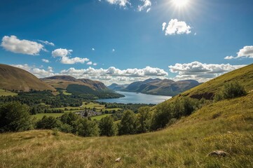 Obraz premium Sunny day over green hills and a peaceful lake with clear blue skies