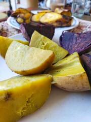 Steamed white sweet potatoes, steamed purple sweet potatoes, and steamed bananas are served as a snack with a cup of coffee or a cup of tea