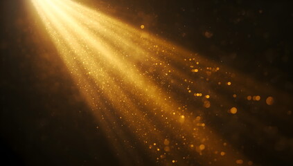 Cinematic and ethereal abstract background of golden light rays and sparkling dust particles on a black background