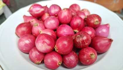 Pile of small, bright red onions on a plate