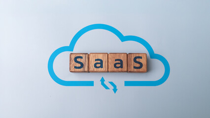 Wooden blocks with SaaS text and cloud computing icon, concept of software as a service, cloud technology, online platform, digital business, startup innovation, and modern IT solution.