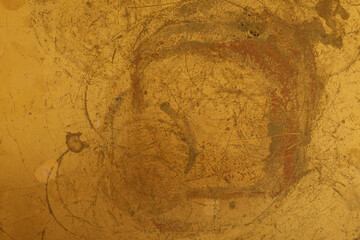 High-resolution image of a golden abstract texture. Perfect for backgrounds, design projects, and artistic creations.  Features scratched metal and grunge effects.