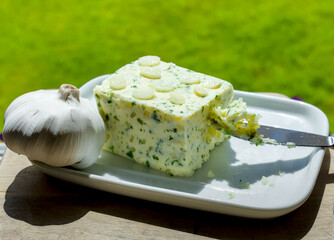 Homemade Butter with Garlic and Parsley, Green Garden Background