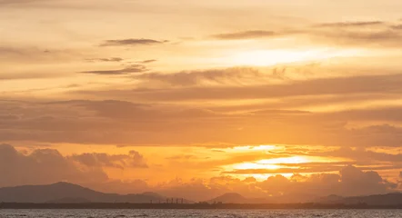 Fotobehang Zomer Sunset sky Clouds over sea in the Evening with Orange, Yellow sunlight on golden hour, Horizon sea sky landscape mountain nature background, Autumn sea Sky  © Nature Peaceful 